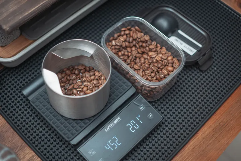 Close-up of coffee beans on a digital kitchen scale, perfect for precision brewing