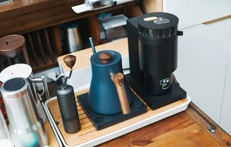 Stylish coffee grinder and kettle setup, perfect for a contemporary home barista